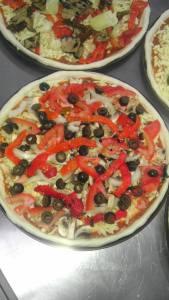 Vegetarian Pizza - homemade pizza sauce, mozzarella, mushrooms, marinated roasted capsicum, fresh tomato, onion and Kalamata olives